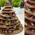 DIY chocolate Christmas tree decorated with nuts, mini cookies, and dried fruits, dusted with cocoa powder for a snowy effect, crafted with a Christmas tree chocolate mould, showcasing layers inspired by fruit and nut chocolate bars, perfect as a Christmas chocolate tree centerpiece